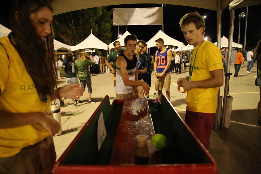 Cal Rhoads (freshman), center, reacts after missing a shot while playing strike bowling on the first night of Ram Welcome activities on Thursday, August 18th. The Ram Welcome weekend featured carnival rides, games, music, and many other activities for incoming CSU freshman to participate in during their first week at Colorado State University. (Forrest Czarnecki/Collegian)