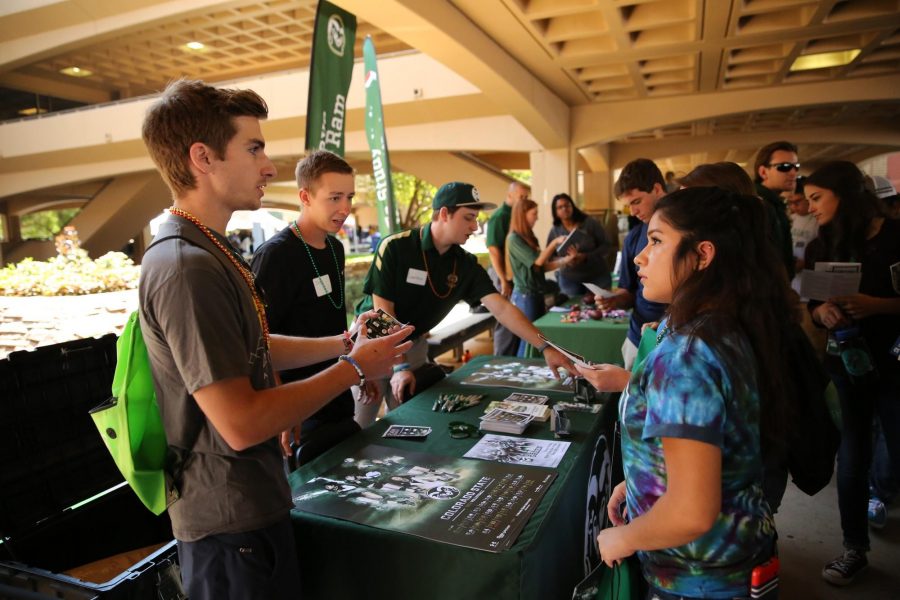 Josh Griesemer (junior), a Sports Broadcasting major, talks to Natalie Roman (freshman), a Biology major, about the athletics programs at Colorado State University on Friday afternoon at the Street Fair. The Street Fair featured information about the departments, clubs, and activities available at CSU for all students. (Forrest Czarnecki | The Collegian)