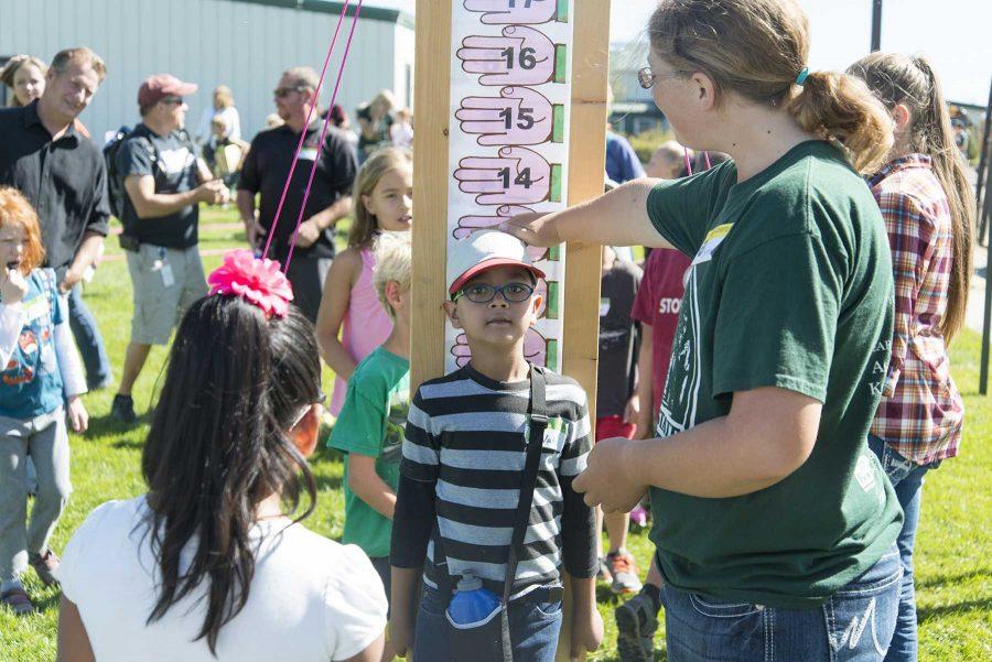 Poudre School District 3rd grader gets his height measured to see if he is big enough to be considered a horse during Ag Adventure at CSU ARDEC on September 28th, 2016 (Luke Walker | Collegian).