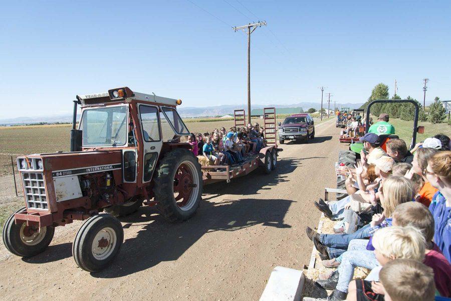 Tractors take Poudre School District students between stations during Ag Adventure at CSU ARDEC on September 28th, 2016 (Luke Walker | Collegian).
