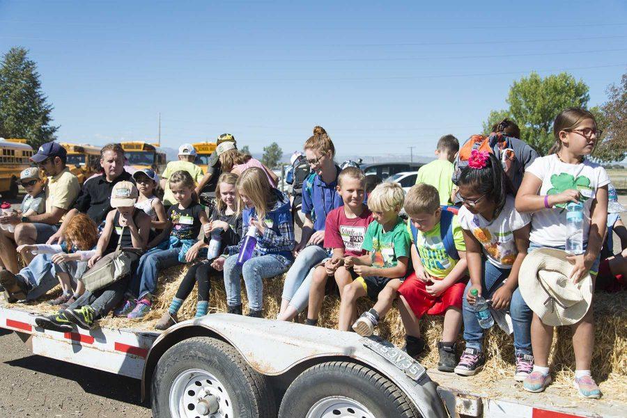 Poudre School District 3rd graders unload from a trailer with hay bales during Ag Adventure at CSU ARDEC on September 28th, 2016 (Luke Walker | Collegian).