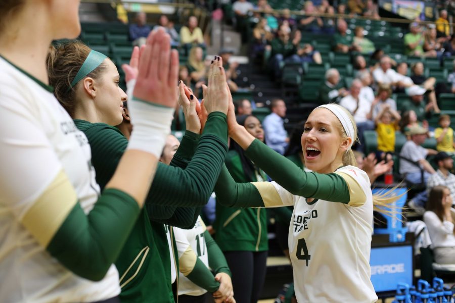 Colorado State University's McKenna Thornlow (4) celebrates with the volleyball team after the Rams score against Fresno State on Thursday night at Moby arena. The Rams beat the Bulldogs in 4 sets. (Forrest Czarnecki | Collegian)