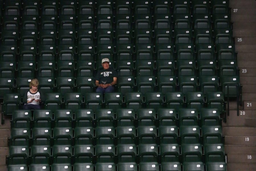A couple of Colorado State University volleyball fans watch the warmups before the CSU basketball game against Fresno State on Thursday evening. (Forrest Czarnecki | Collegian)