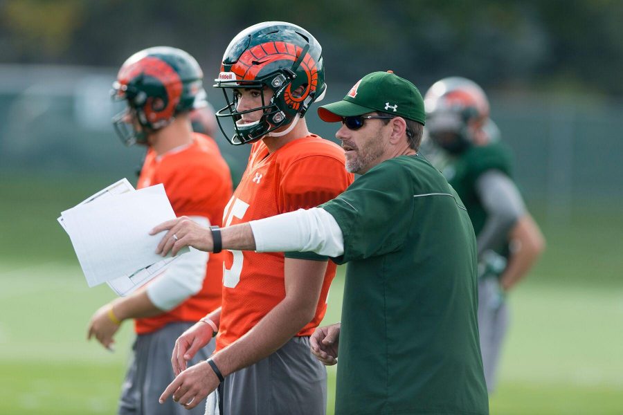 Coach Mike Bobo gives Collin Hill (15) instruction during practice Sept. 14 Photo credit: Luke Walker