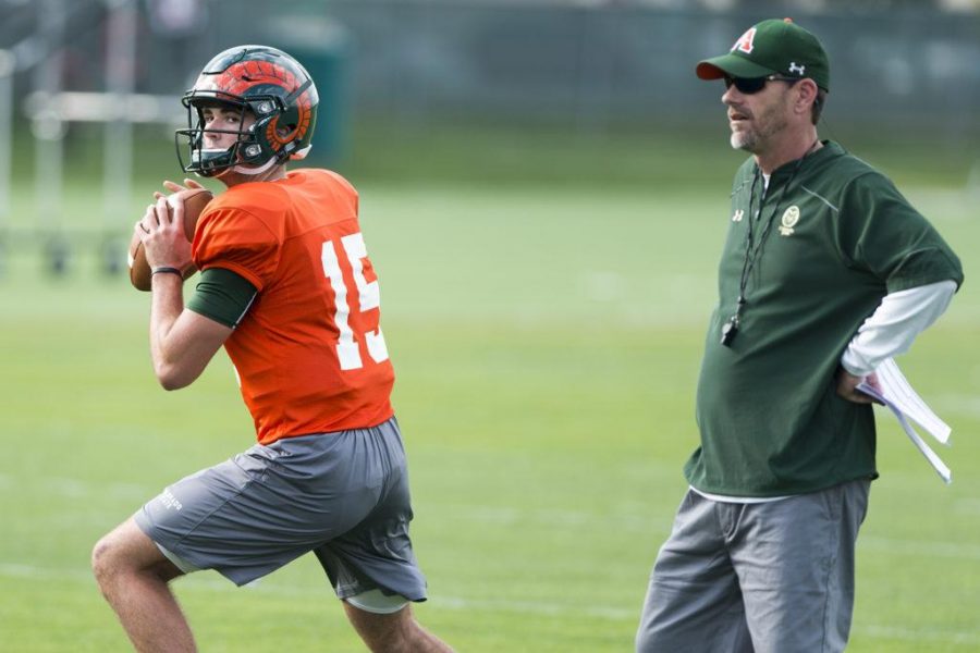 Colorado State University Quaterback #15 Collin Hill gets ready to make a pass (left) with coach Mike Bobo (right) during practice on September 14th, 2016 (Luke Walker | Collegian).