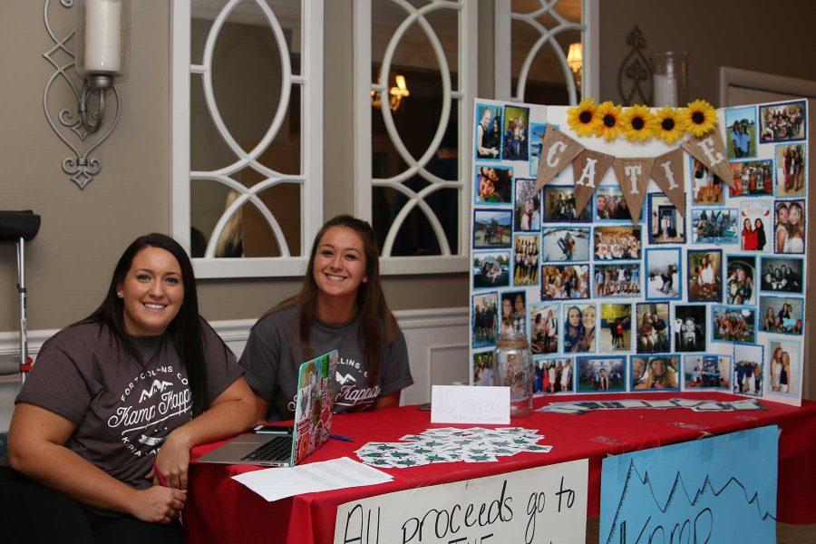 Kappa Kappa Gamma members Sabrina Romeo and Nikki Martinez sell stickers to benefit Catie Abeyta Scholarship Fund. (Elliott Jerge | Collegian)