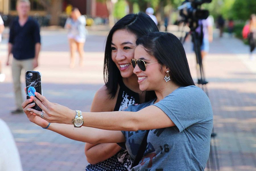 A CSU student takes a selfie with Michelle Kwan during her visit to campus campaigning for Hillary Clinton. Photo credit: Elliott Jerge