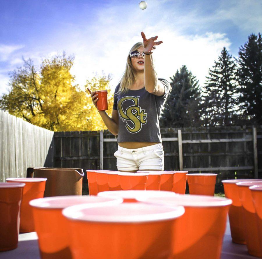Sophomore English student major Erica Greenfield competes with friends in a traditional game of Water Pong to kick-off homecoming weekend.