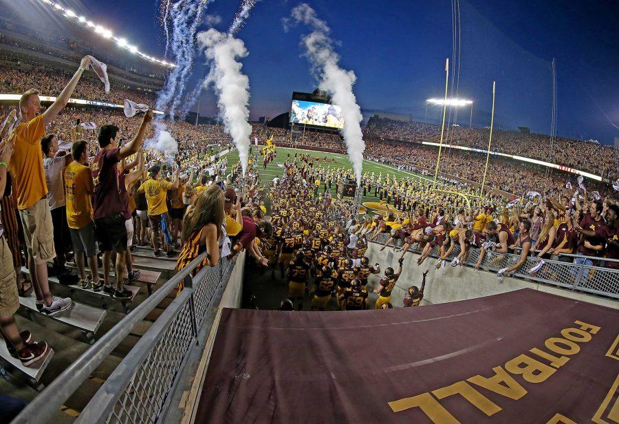 Gold Gopher fans cheer as the Minnesota players take the field against Texas Christian at TCF Bank Stadium in Minneapolis on Thursday, Sept. 3, 2015. (Elizabeth Flores/Minneapolis Star Tribune/TNS)