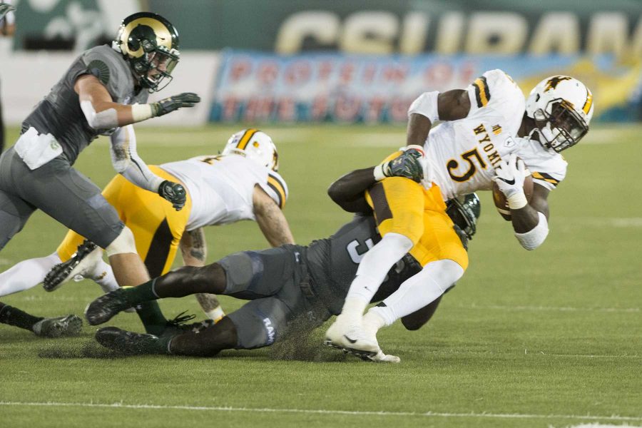 CSU line backer Bryan Ohene-Gyeni (36) makes a tackle against Wyoming running back Brian Hill (5) at Hughes Stadium during the boarder war. CSU lost 38-17 on October 1st, 2016 (Luke Walker | Collegian).