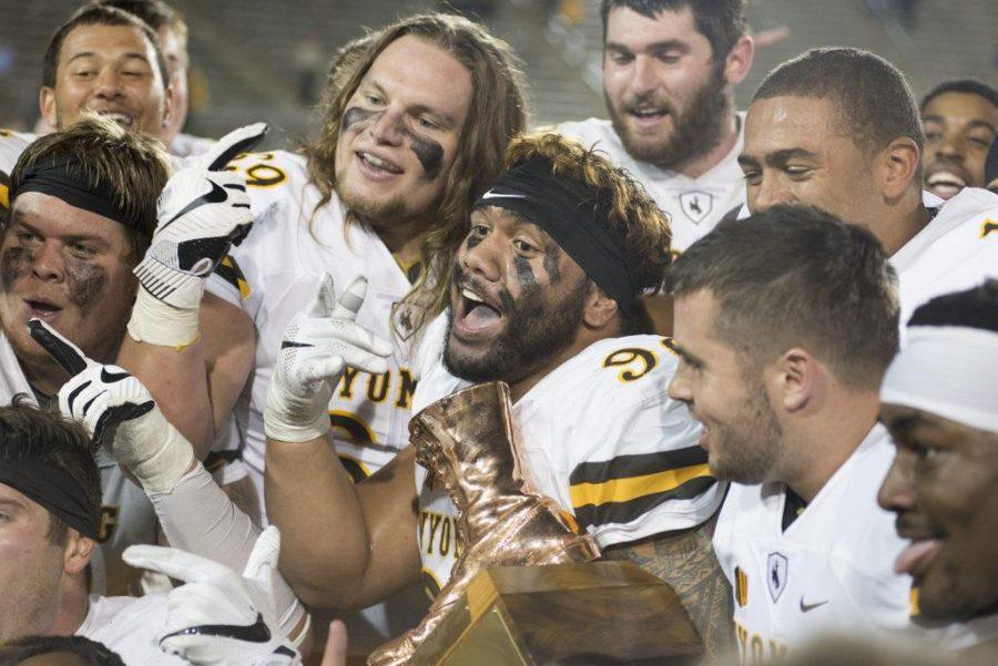 Wyoming football players celebrate winning the boarder war against CSU with the boot. CSU lost 38-17 on October 1st, 2016 (Luke Walker | Collegian).