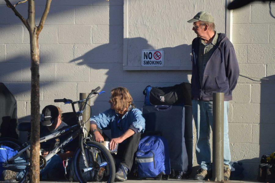 Three men with their backpacks full of their belongings wait outside the Fort Collins Rescue Mission Oct. 26, 2016. (The Collegian file photo)  