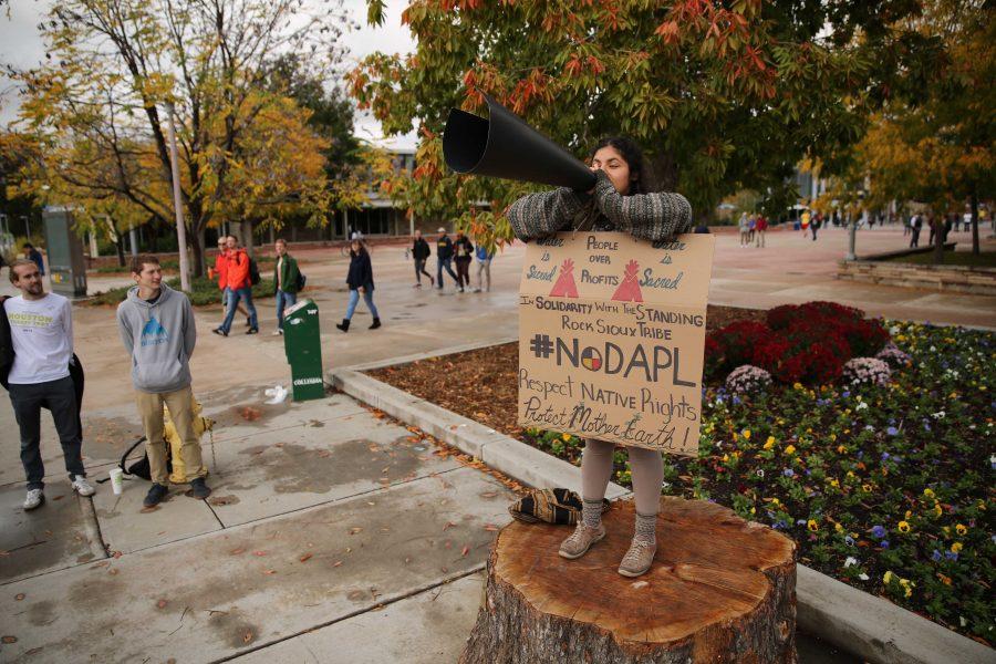 Colorado State University student Griselda Landa-Posas, on stump, shouts and protests the Dakota Access Pipeline on Thursday afternoon in the plaza. Students gathered in the plaza on Thursday afternoon to protest the controversial pipeline. (Forrest Czarnecki | Collegian)