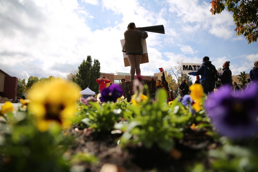 Colorado State University student Griselda Landa-Posas, on stump, shouts and protests the Dakota Access Pipeline on Thursday afternoon in the plaza. Students gathered in the plaza on Thursday afternoon to protest the controversial pipeline. (Forrest Czarnecki | Collegian)
