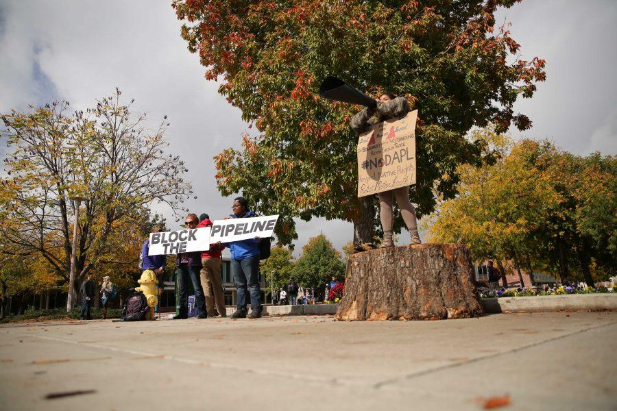 Colorado State University senior Griselda Landa-Posas, on stump, shouts and protests the Dakota Access Pipeline on Thursday afternoon in the plaza. Students gathered in the plaza on Thursday afternoon to protest the controversial pipeline.  (Forrest Czarnecki | Collegian)