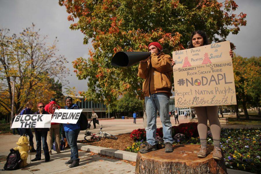 Colorado State University students Griselda Landa-Posas, right, and Adam Lovell, left, shout and protest the Dakota Access Pipeline on Thursday afternoon in the plaza. Students gathered in the plaza on Thursday afternoon to protest the controversial pipeline. (Forrest Czarnecki | Collegian)