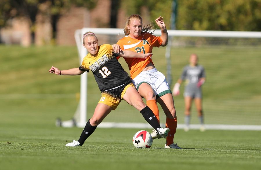 Colorado State University's Halley Havlicek (21) fights for possession of the ball against Colorado College's Dana Gornick (12) during the first half of the game on Friday afternoon at the Lagoon Field. The Rams were beat by the Tigers 2-0.