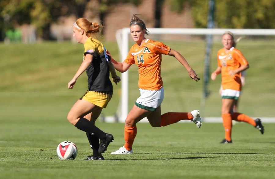 Colorado State University's Hannah Gerdin (14) defends against a Colorado College forward during the first half of the game on Friday afternoon at the Lagoon Field. The Rams were beat by the Tigers 2-0. (Forrest Czarnecki | Collegian)