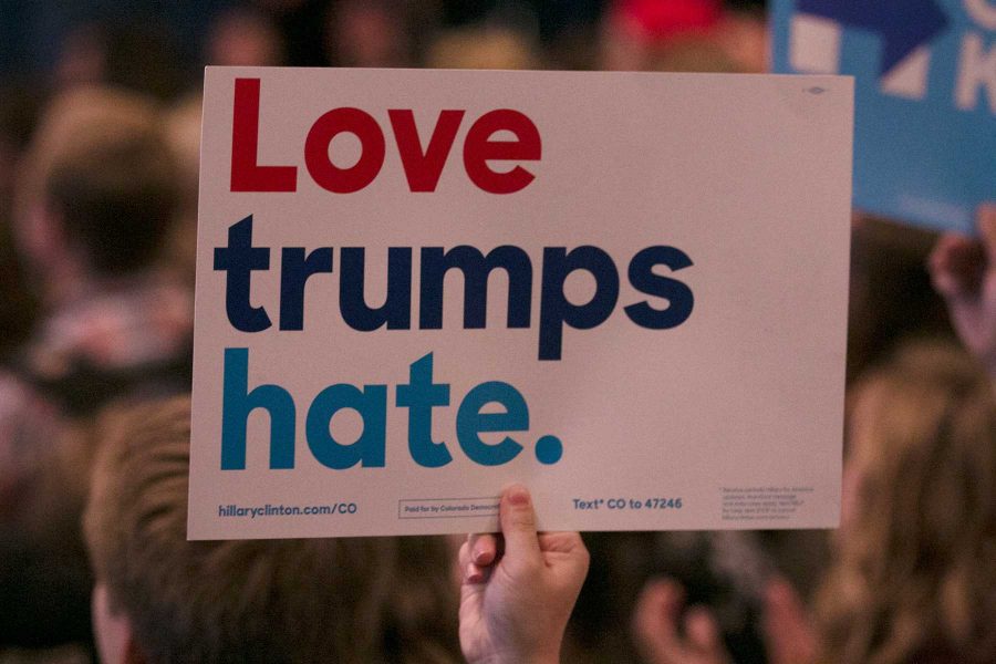 A Hillary Clinton supporter holds up a sign that states Love Trumps Hate at a Bernie Sanders rally on October 17, 2016 at Colorado State University. (Elliott Jerge | Collegian)