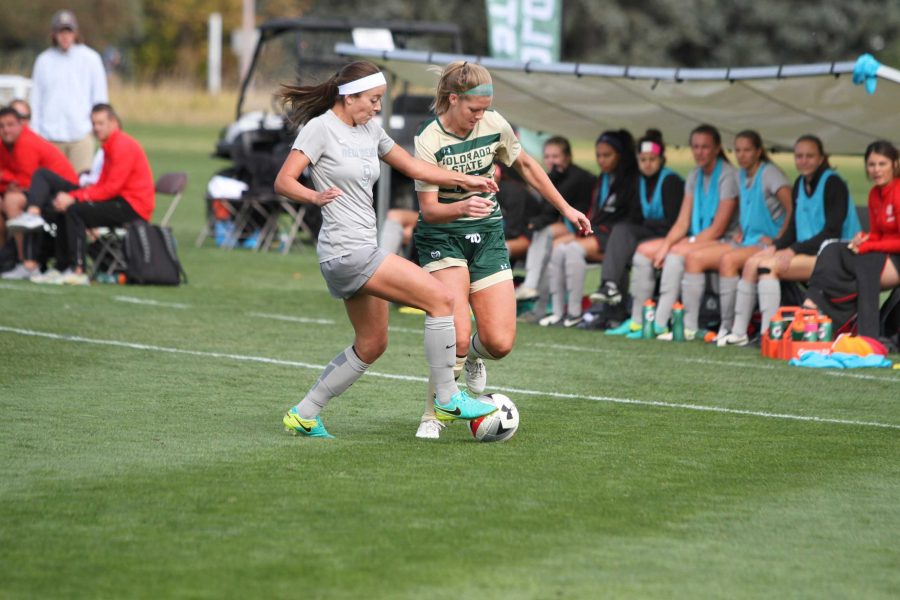 Hannah Gerdin (14) tries to shake off a Lobo defender during the Rams 1-0 loss against New Mexico. (Javon Harris | Collegian)
