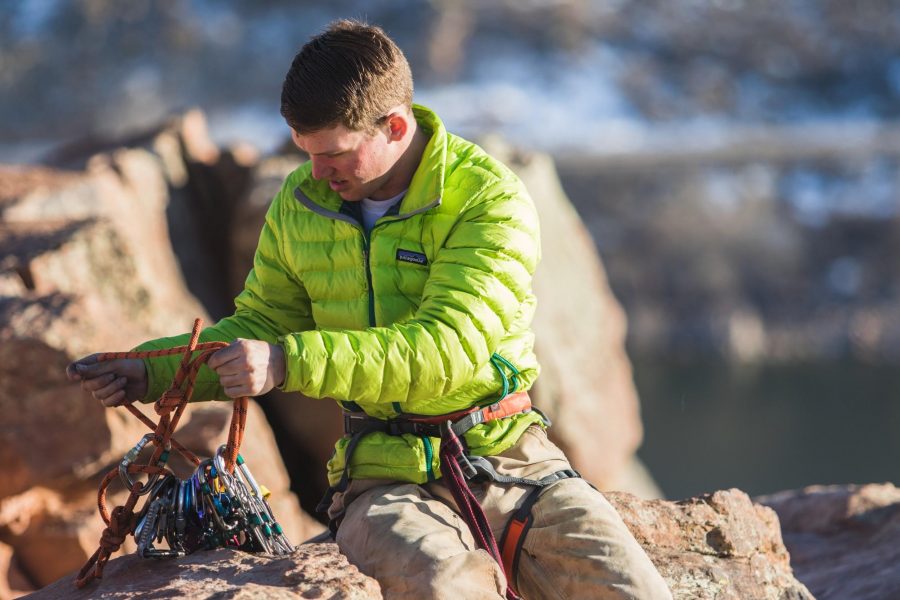 Matt Johnston double checks his rope and cams after anchoring his rope on top of Duncan's Ridge  on Horsetooth Reservoir, Fort Collins, Colo. Photo credit: Grant Whitty
