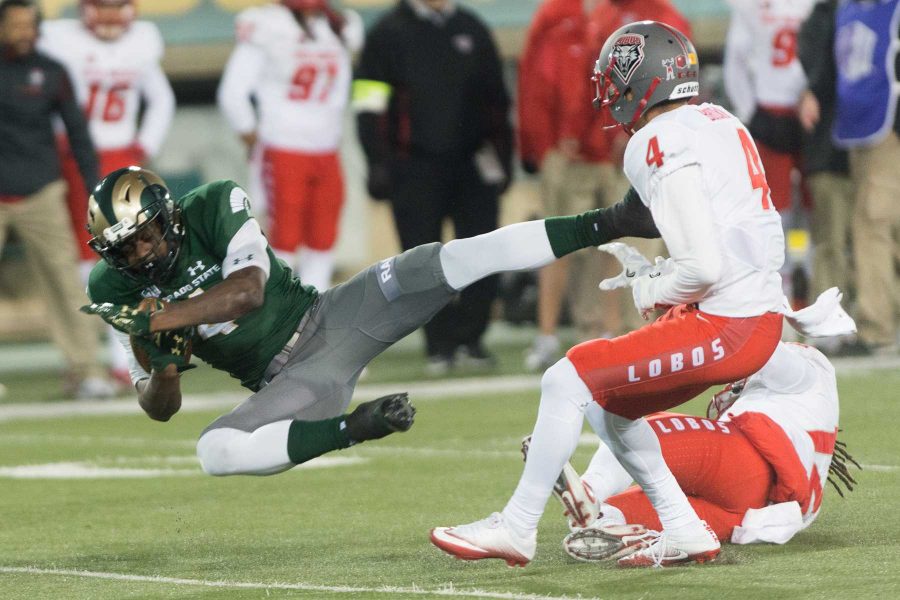 Colorado State University wide receiver Michael Gallup (4) trips over a New Mexico defender at Hughes Stadium on Nov 19. This was the final game at Hughes Stadium before moving to an on campus stadium in 2017. (Luke Walker | Collegian)