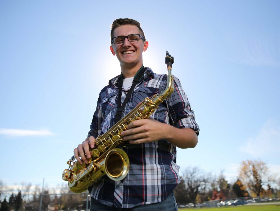 Colorado State University's Trenten Robinson poses for a portrait with his saxophone at the field where the marching band practices. Photo credit: Forrest Czarnecki
