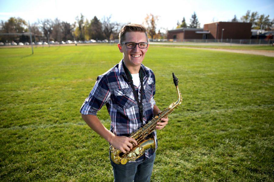 Colorado State University's Trenten Robinson poses for a portrait with his saxophone at the field where the marching band practices. (Forrest Czarnecki | Collegian)