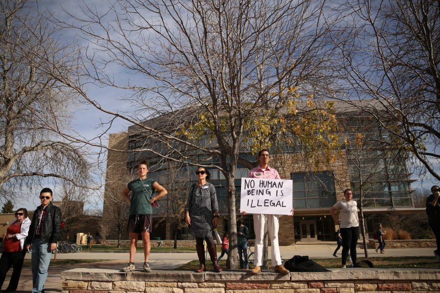 Galeth Bolanos holds a sign in support of undocumented citizens during a DACA rally in the Plaza on Monday. (Forrest Czarnecki | Collegian)