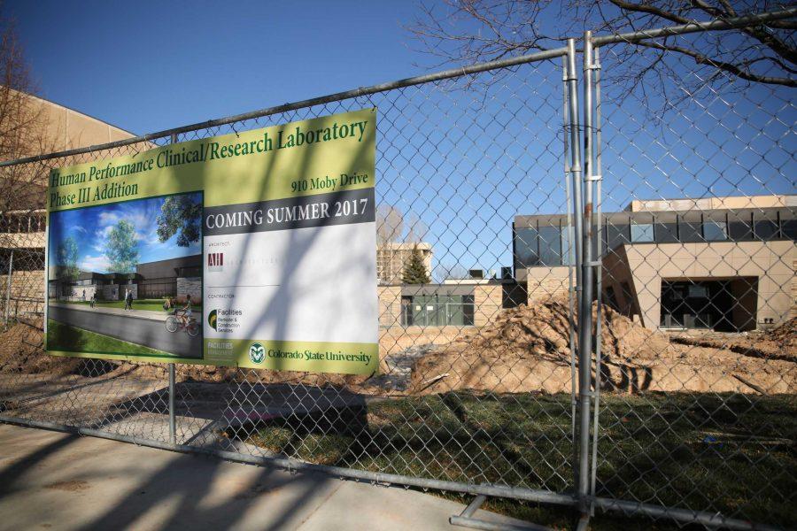 A sign indicating some of the predicted architecture and building plans for the expansion building of the Health and Exercise Sciences facilities is seen on the south side of the HES building on Wednesday morning. Groundbreaking for the new building started on Nov. 13. (Forrest Czarnecki | Collegian)