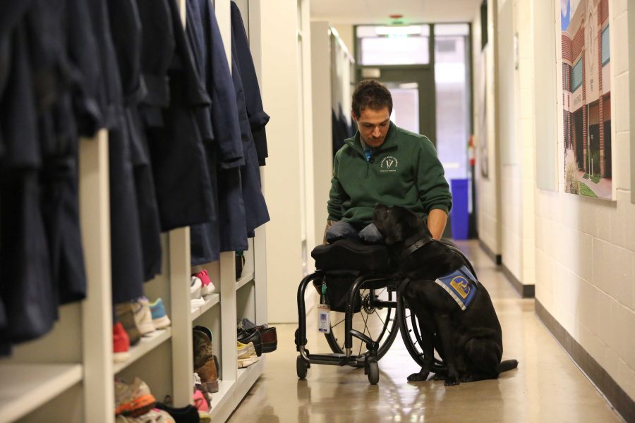 Bernard Dime shares a moment with his service dog, Corky, in the Anatomy building. Dime is the first paraplegic student in Colorado State University's veterinarian program. (Forrest Czarnecki | Collegian)