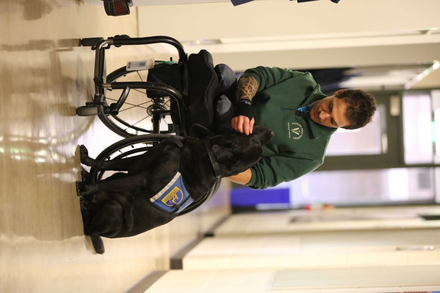 Bernard Dime shares a moment with his service dog, Corky, in the Anatomy building. Dime is the first paraplegic student in Colorado State University's veterinarian program. (Forrest Czarnecki | Collegian)
