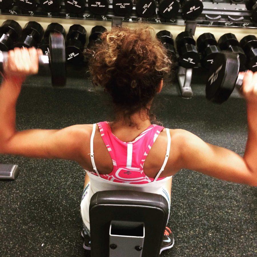 Begin with the weights at your shoulders and push upwards. Photo credit: Hayley Blackburn