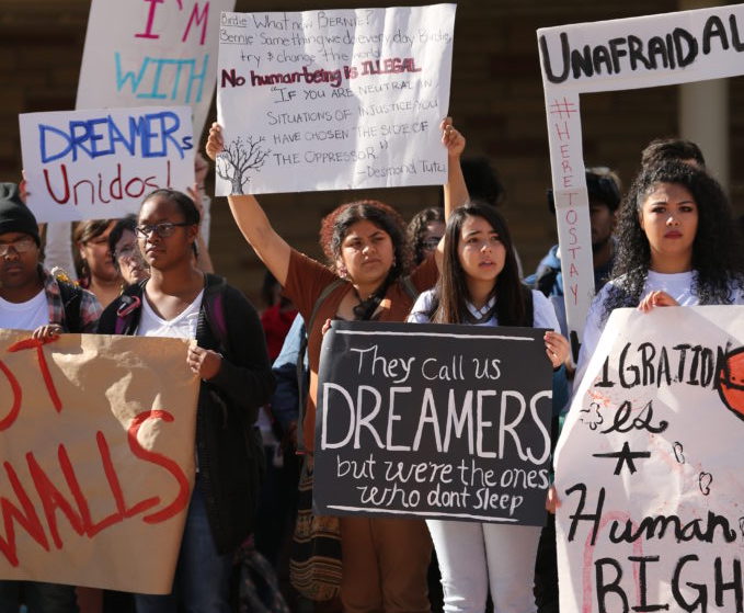 Supporters of  DACA hold signs in support of DACA, and the rights of undocumented persons at Colorado State University during a rally in the Plaza in February. (Forrest Czarnecki | Collegian)