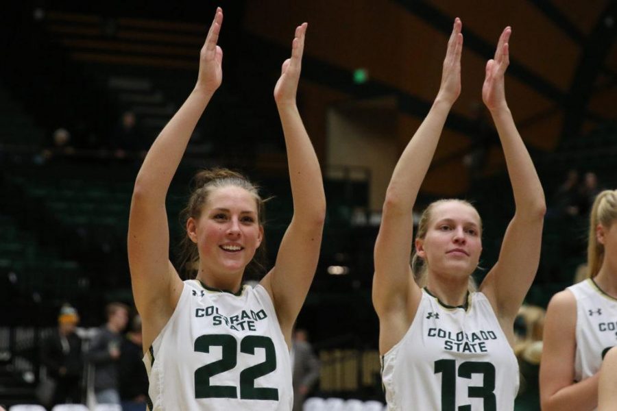 Senior Elin Gustavsson (22) and Senior Ellen Nystrom (13) clap along with the pep band to the CSU Fight Song (Elliott Jerge | Collegian)