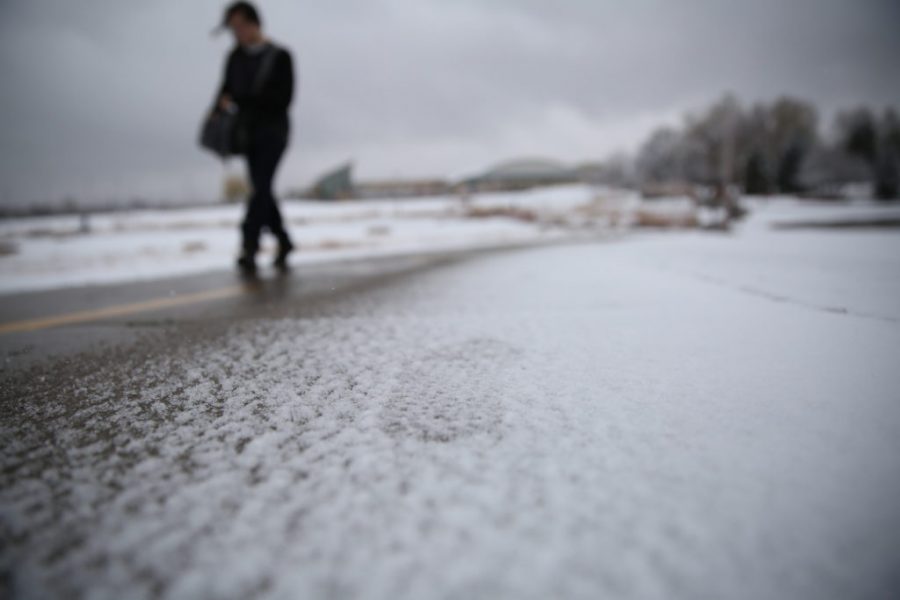 Footsteps are seen in the snow on sidewalk by the Lagoon on Thursday afternoon. (Forrest Czarnecki | Collegian)