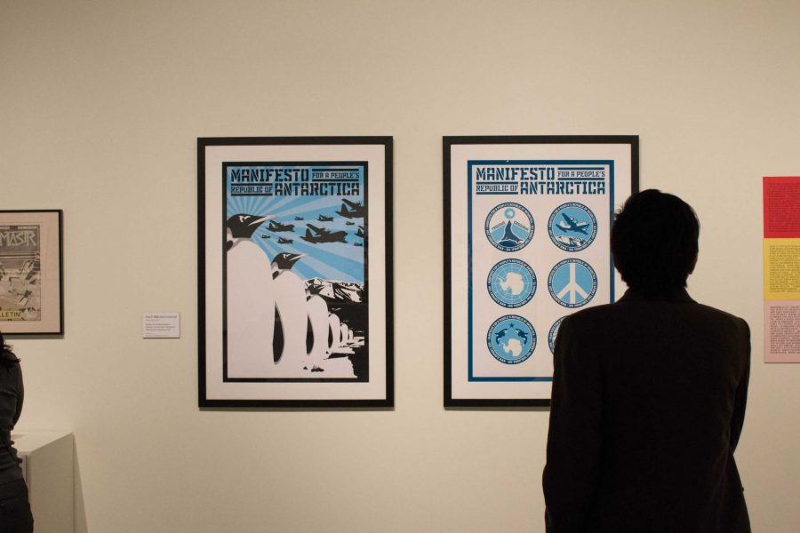 Man looks at posters in the "Identity/Perspective" exhibit CSU's Gregory Allicar Museum of Art opening reception for Spring 2017. Photo credit: Ashley Potts