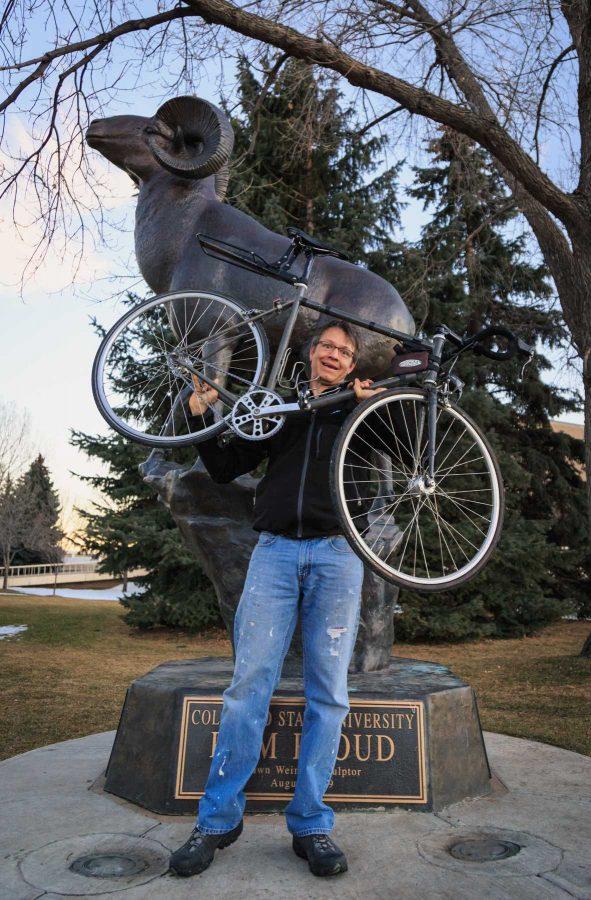 Matthew Carnal holds the bike he rode across the country on as he raises money to ride across Russia. January 18, 2017 (Davis Bonner | Collegian)