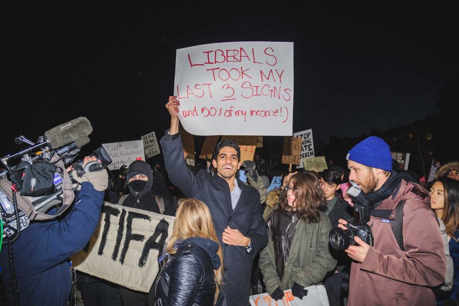 A counter protester to those opposing  Milo Yiannopoulos' event at CU displays his poster (Davis Bonner | Collegian)