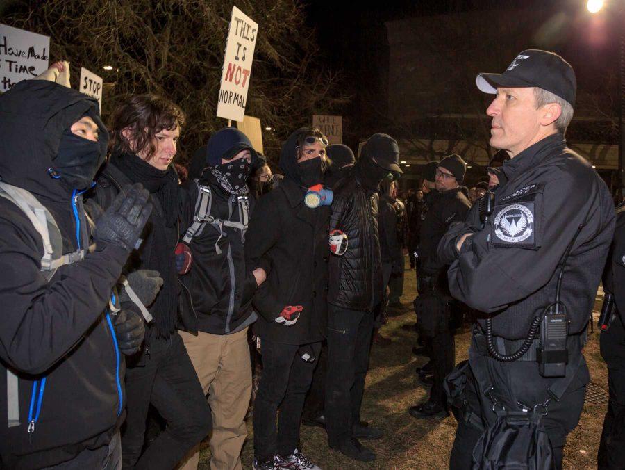 Protesters to Milo Yiannopoulos' event at CU stand face to face with the police officers tasked with controlling crowds. (Davis Bonner | Collegian)