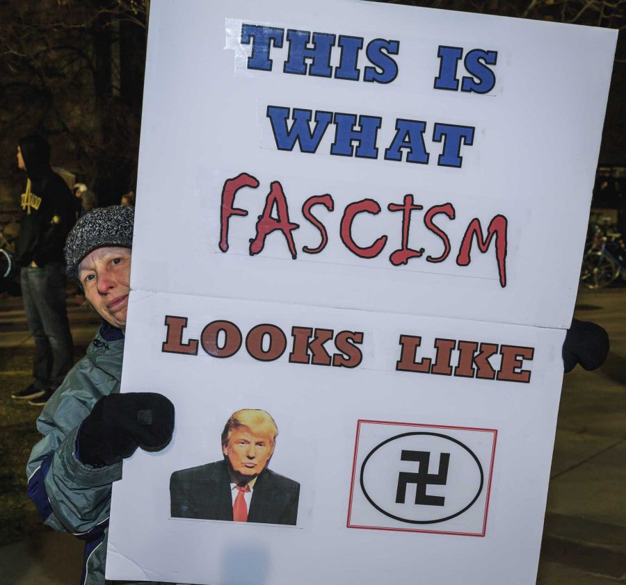A protester to Milo Yiannopoulos' appearance on CU's campus shows of their sign (Davis Bonner | Collegian)