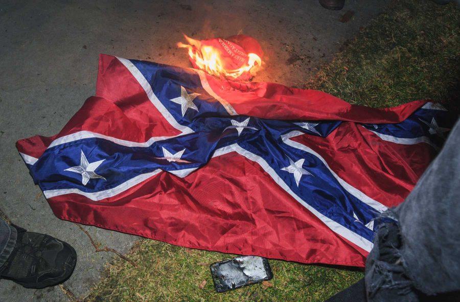 During Milo Yiannopolos' visit to CU, protestors burned a confederate flag and a "Make America Great Again" hat. (Davis Bonner | Collegian)