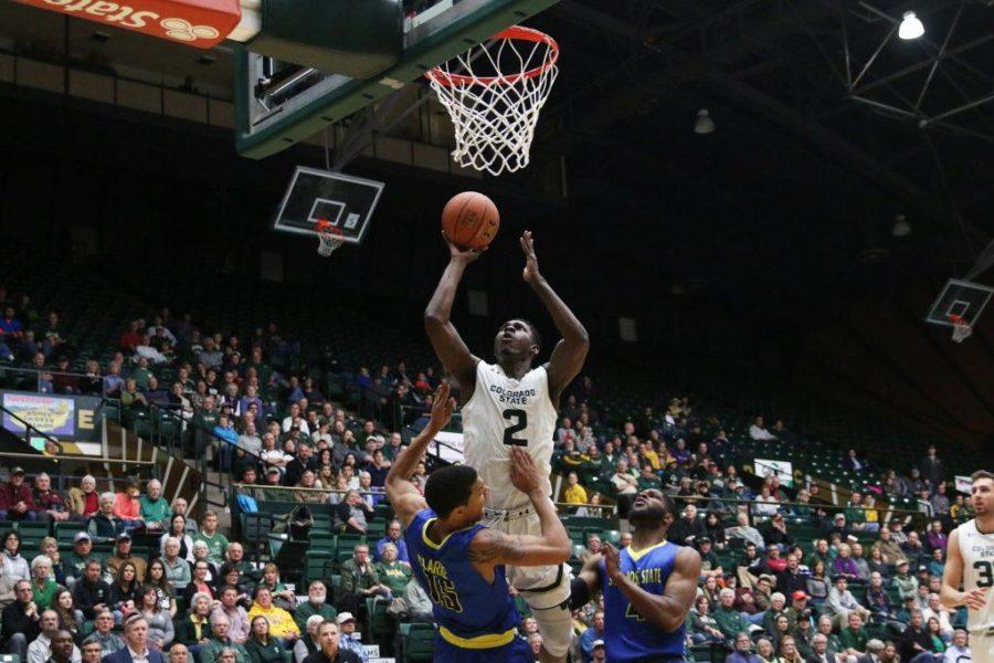Senior Emmanuel Omogbo goes for layup over two San Jose State players on January 25, 2017. (Elliott Jerge | Collegian)
