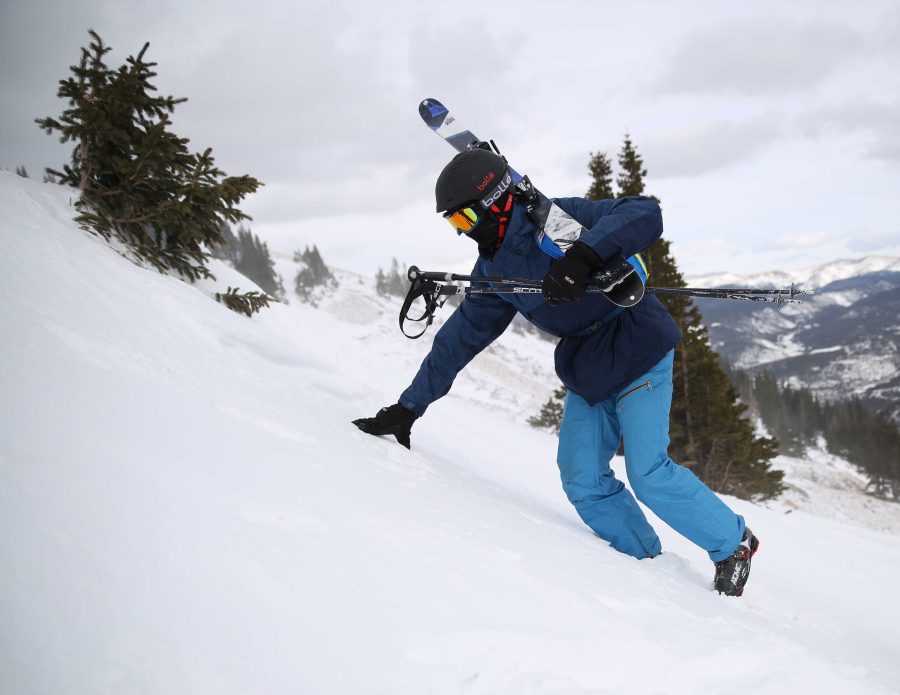Josh Hill, of Conifer, Colorado, climbs up a snowfield to the top of a ski run at Breckenridge ski resort in late December. Many ski resorts across Colorado enjoyed above average snowfall at the end of 2016 and through the beginning of the new year. (Forrest Czarnecki | Collegian)