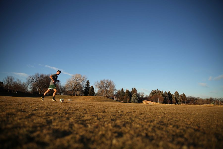 Colorado State University junior Ryan Schlachter practices his soccer skills at the Lagoon Field as the sun sets on January 18th. (Forrest Czarnecki | Collegian)