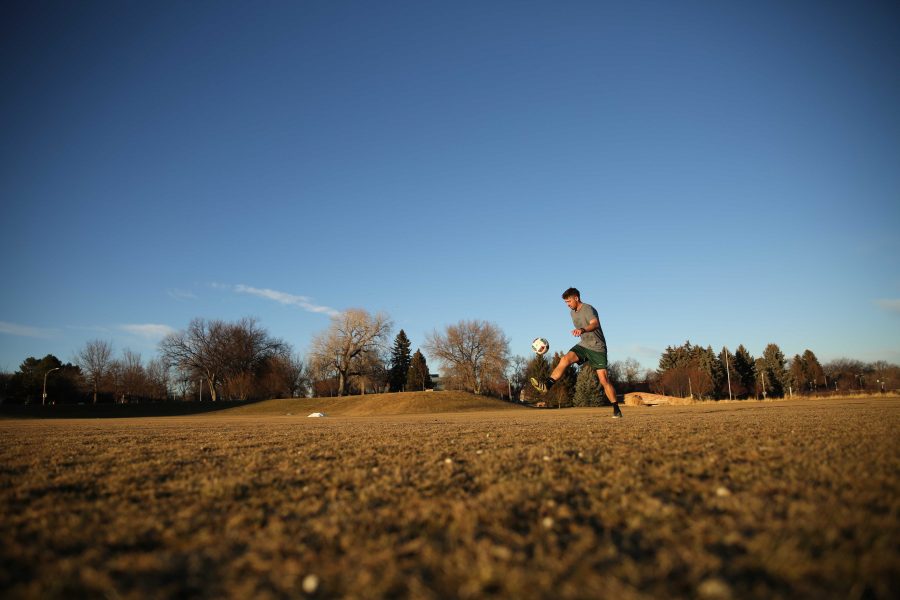 Colorado State University junior Ryan Schlachter practices his soccer skills at the Lagoon Field as the sun sets on January 18th. (Forrest Czarnecki | Collegian)