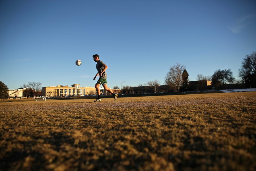 Colorado State University junior Ryan Schlachter practices his soccer skills at the Lagoon Field as the sun sets on January 18th. (Forrest Czarnecki | Collegian)