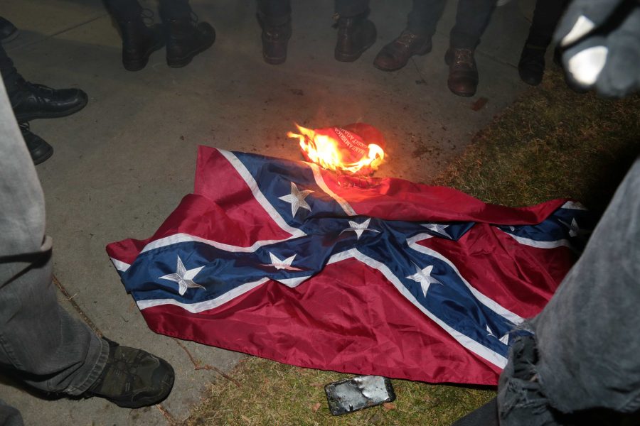 During Milo Yiannopolos' visit to CU, protestors burned a confederate flag and a "Make America Great Again" hat. (Davis Bonner | Collegian)