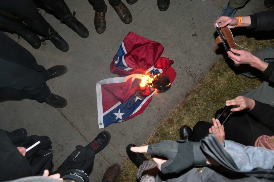 During Milo Yiannopolos' visit to CU, protestors burned a confederate flag and a "Make America Great Again" hat. (Davis Bonner | Collegian)