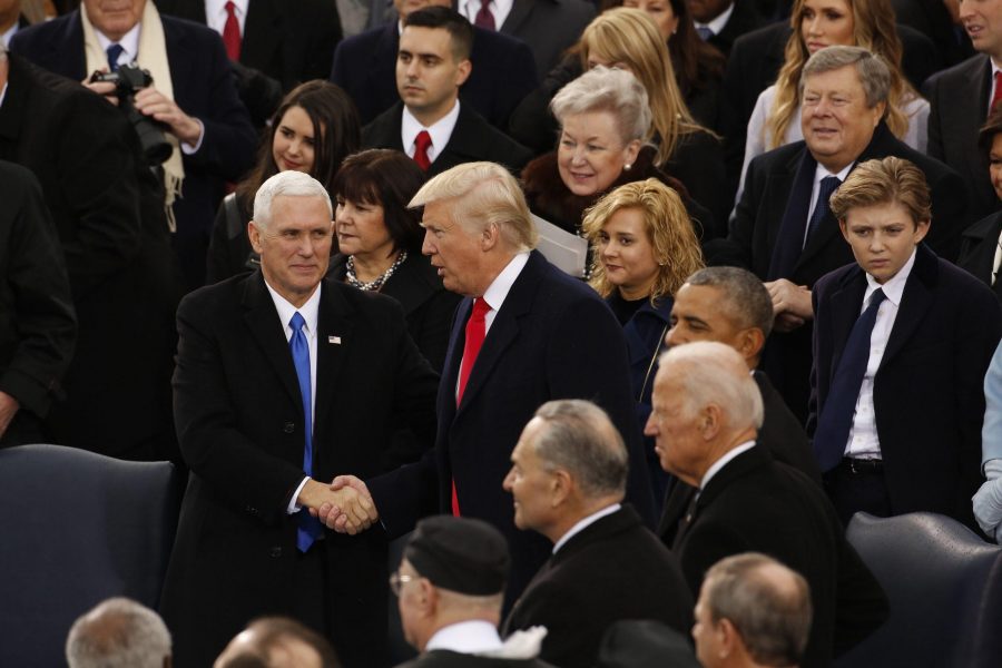 President Donald Trump shakes hands with VP Mike Pence as he arrives on Jan. 20, 2017 in Washington, D.C. (Carolyn Cole/Los Angeles Times/TNS)